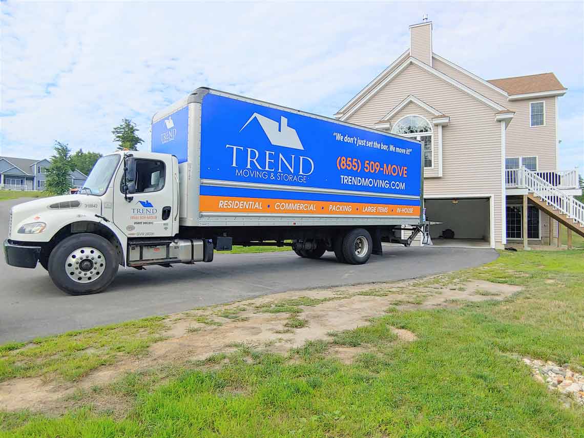 Image of the Trend Moving truck outside of a home. Contact out moving company in New Castle NH for your next move